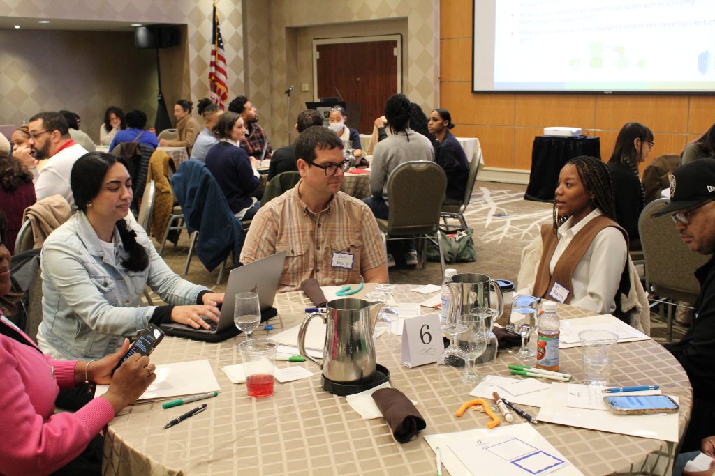Teachers seated at a table during a professional conference