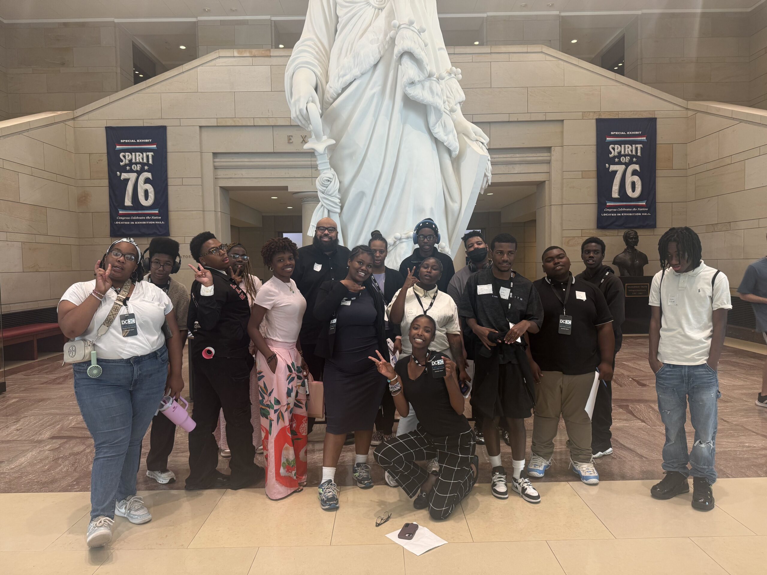 DC3C Summer Pathways student participants and staff pose in front of a statue in a government building